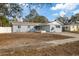 Newly renovated home with gray exterior, landscaping, and driveway at 2307 Mary Sue St, Largo, FL 33774