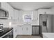 Modern white kitchen with stainless steel appliances and quartz countertops at 2307 Mary Sue St, Largo, FL 33774