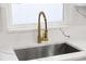 Modern kitchen sink with gold faucet and white quartz countertop at 2307 Mary Sue St, Largo, FL 33774