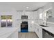 Newly renovated kitchen with white cabinets and stainless steel appliances at 2307 Mary Sue St, Largo, FL 33774