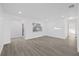 Bright living room with wood-look floors and access to hallway at 2307 Mary Sue St, Largo, FL 33774