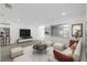 Living room with white sectional sofa and large TV at 2307 Mary Sue St, Largo, FL 33774