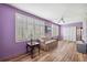 Bedroom with lavender walls, wood-look floors, and white shutters at 2430 Florentine Way # 38, Clearwater, FL 33763