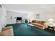 Living room with green carpet, a sofa, and a fireplace at 2430 Florentine Way # 38, Clearwater, FL 33763