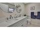 Well-lit bathroom featuring a double vanity with modern fixtures and clean, white finishes at 2603 Royal Ridge Dr, Spring Hill, FL 34606