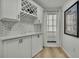 Stylish butler's pantry with white cabinetry, wine rack, and patterned backsplash at 2603 Royal Ridge Dr, Spring Hill, FL 34606