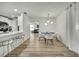 Bright dining room featuring modern light fixture and seating for six, with kitchen and living room views at 2603 Royal Ridge Dr, Spring Hill, FL 34606