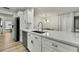 Bright kitchen with white cabinets, stainless steel appliances, and a breakfast bar that seats two at 2603 Royal Ridge Dr, Spring Hill, FL 34606