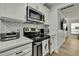 Modern kitchen with stainless steel appliances, stylish backsplash, and ample counter space at 2603 Royal Ridge Dr, Spring Hill, FL 34606