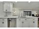 Bright kitchen with white cabinets, stainless steel appliances, a breakfast bar and an eat-in dining area at 2603 Royal Ridge Dr, Spring Hill, FL 34606