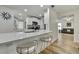 Bright, open kitchen with white cabinets, stainless steel appliances, and a breakfast bar at 2603 Royal Ridge Dr, Spring Hill, FL 34606