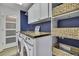 Well-equipped laundry room with modern washer, dryer, storage, and wooden countertops at 2603 Royal Ridge Dr, Spring Hill, FL 34606