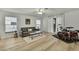 Inviting living room featuring sleek flooring, comfortable gray couch, and bright natural light at 2603 Royal Ridge Dr, Spring Hill, FL 34606