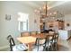 Bright dining room features a wood table, modern chandelier, and seating for eight at 2993 Breezy Meadows Dr, Clearwater, FL 33760