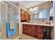 Clean bathroom with wood cabinets and shower stall at 322 S Port Royal Ln, Apollo Beach, FL 33572