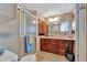 Clean bathroom with wood cabinets and shower stall at 322 S Port Royal Ln, Apollo Beach, FL 33572