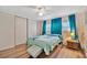 Bedroom with ceiling fan, teal curtains, and wood-look flooring at 322 S Port Royal Ln, Apollo Beach, FL 33572