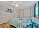 Bedroom with ceiling fan, double closet, and floral bedding at 322 S Port Royal Ln, Apollo Beach, FL 33572