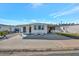 Single-wide mobile home with carport and spacious paved driveway at 322 S Port Royal Ln, Apollo Beach, FL 33572
