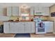 Bright kitchen with white cabinets, modern appliances, and laminate flooring at 322 S Port Royal Ln, Apollo Beach, FL 33572
