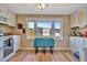 Kitchen features a table for two, ample counter space, and a view of the backyard at 322 S Port Royal Ln, Apollo Beach, FL 33572