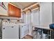Laundry room with washer, dryer, and storage cabinets at 322 S Port Royal Ln, Apollo Beach, FL 33572