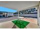 Covered patio with table and artificial turf at 322 S Port Royal Ln, Apollo Beach, FL 33572