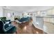 Open living space with hardwood floors, teal sofas, and a kitchen at 3621 19Th Street N, St Petersburg, FL 33713