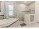 Spa-like bathroom with a walk-in shower and a large soaking tub at 4041 Woodland Retreat Blvd, New Port Richey, FL 34655