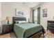 Cozy bedroom with a queen bed, nightstands, and green accents at 4041 Woodland Retreat Blvd, New Port Richey, FL 34655