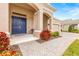 Inviting front entrance with a navy blue double door and a brick walkway at 4041 Woodland Retreat Blvd, New Port Richey, FL 34655