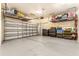 Garage with overhead storage and epoxy flooring at 4041 Woodland Retreat Blvd, New Port Richey, FL 34655