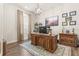Spacious home office with hardwood floors and a large desk at 4041 Woodland Retreat Blvd, New Port Richey, FL 34655