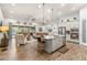 Open-concept kitchen with island, stainless steel appliances, and hardwood floors at 4041 Woodland Retreat Blvd, New Port Richey, FL 34655