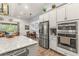 Kitchen features stainless steel appliances and an island at 4041 Woodland Retreat Blvd, New Port Richey, FL 34655