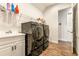 Modern laundry room with front-load washer and dryer and storage at 4041 Woodland Retreat Blvd, New Port Richey, FL 34655