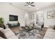 Open living room with comfortable seating and access to patio at 4041 Woodland Retreat Blvd, New Port Richey, FL 34655