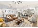 Spacious living room with leather sofas and a large TV at 4041 Woodland Retreat Blvd, New Port Richey, FL 34655