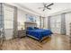 Main bedroom with a king-size bed and wood flooring at 4041 Woodland Retreat Blvd, New Port Richey, FL 34655
