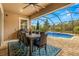 Outdoor patio with dining set overlooking the pool at 4041 Woodland Retreat Blvd, New Port Richey, FL 34655