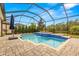 Inviting screened pool and spa with paver deck at 4041 Woodland Retreat Blvd, New Port Richey, FL 34655