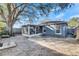 Large backyard with screened patio, grill, and mature tree at 410 Pine Pointe Ct, Seffner, FL 33584