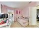 Pink bedroom with Hello Kitty decor and a workspace at 410 Pine Pointe Ct, Seffner, FL 33584