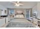 Serene bedroom with large windows and a ceiling fan at 410 Pine Pointe Ct, Seffner, FL 33584