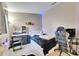 Bright bedroom with a bed, vanity, and gaming setup at 410 Pine Pointe Ct, Seffner, FL 33584