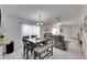 Dining room with a square table and four chairs, adjacent to living room at 410 Pine Pointe Ct, Seffner, FL 33584