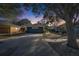 House exterior at dusk with a gray garage door and landscaping at 410 Pine Pointe Ct, Seffner, FL 33584