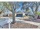 One-story house with gray garage door and mature trees in the front yard at 410 Pine Pointe Ct, Seffner, FL 33584