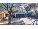 One-story house with gray garage and a tree-lined street at 410 Pine Pointe Ct, Seffner, FL 33584