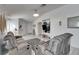 Living room with gray sofas and tile floors, open to dining area at 410 Pine Pointe Ct, Seffner, FL 33584